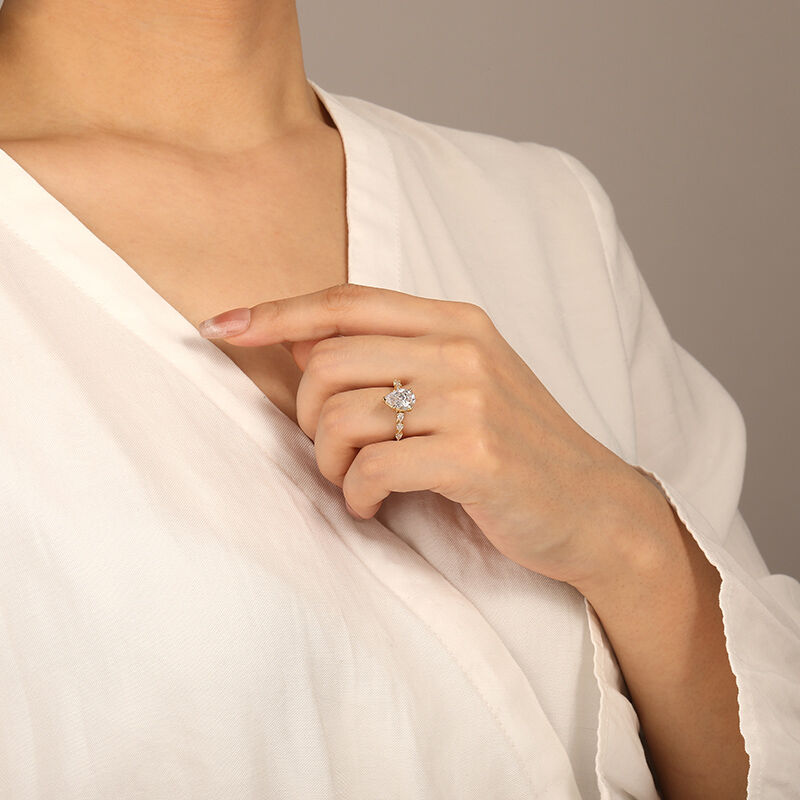 "A Tear-drop of Love" Pear Cut Side Stone Engagement Ring