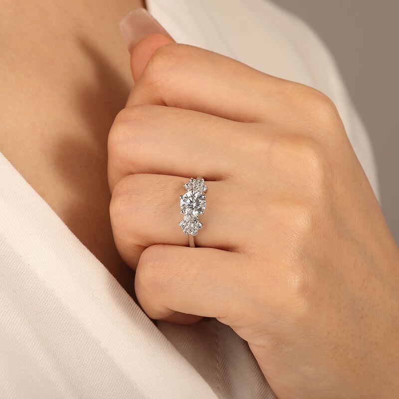 "The Whisper Of Snows" Round Cut Side Stone Engagement Ring